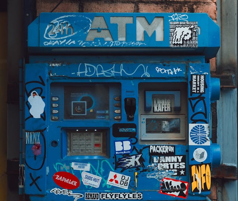 Graffiti-Covered ATM on Brick Wall – Financial Crime Risk Illustration