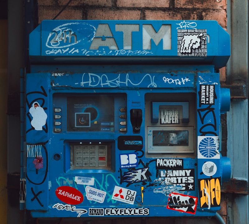 Graffiti-Covered ATM on Brick Wall – Financial Crime Risk Illustration